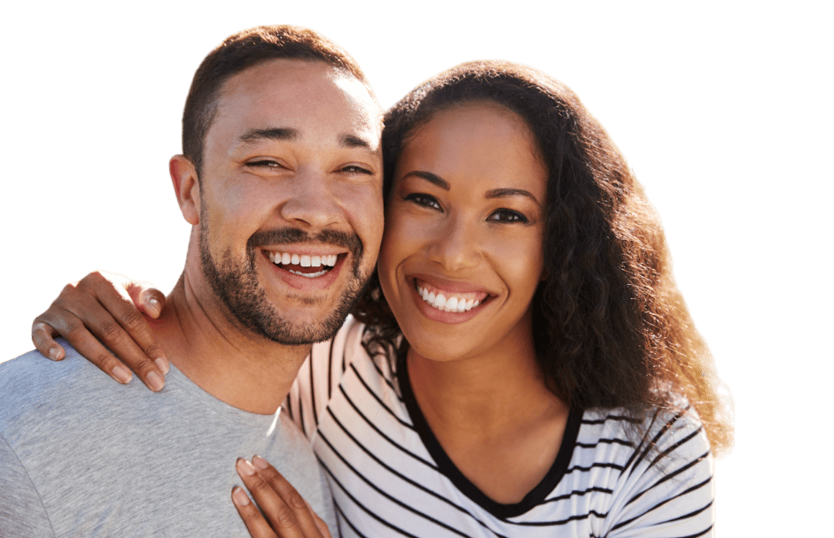 A smiling couple poses closely together, with the woman resting her hand on the man's shoulder. The background is a plain green.