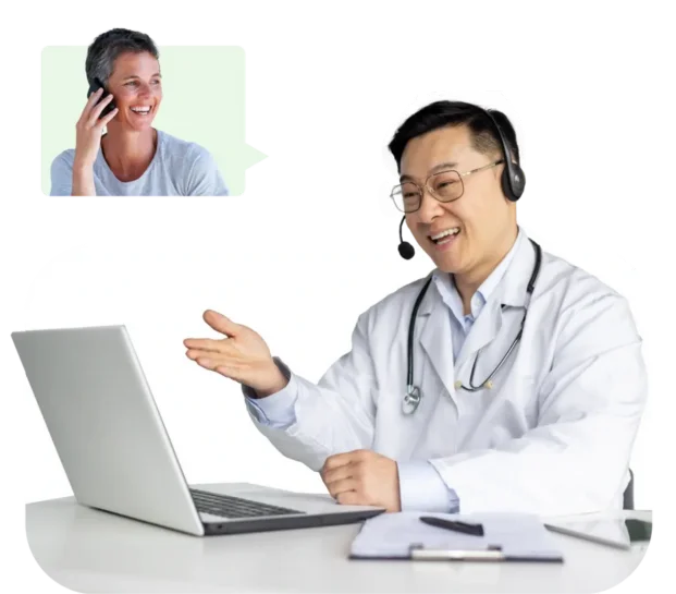 A doctor wearing a headset sits at a desk using a laptop, engaging in a video call. An inset shows a person smiling while talking on their phone.